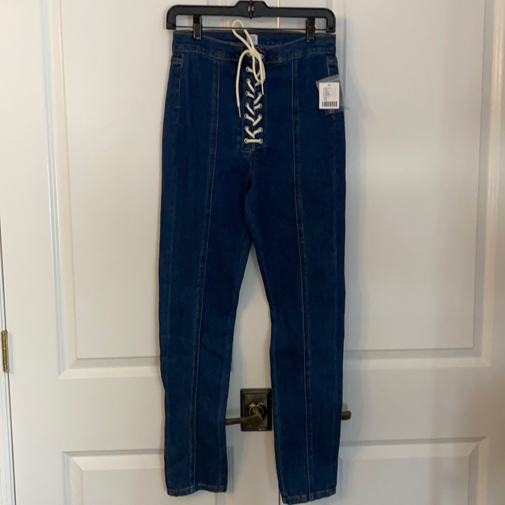Brand new dark wash skinny jean w/ lace up detail